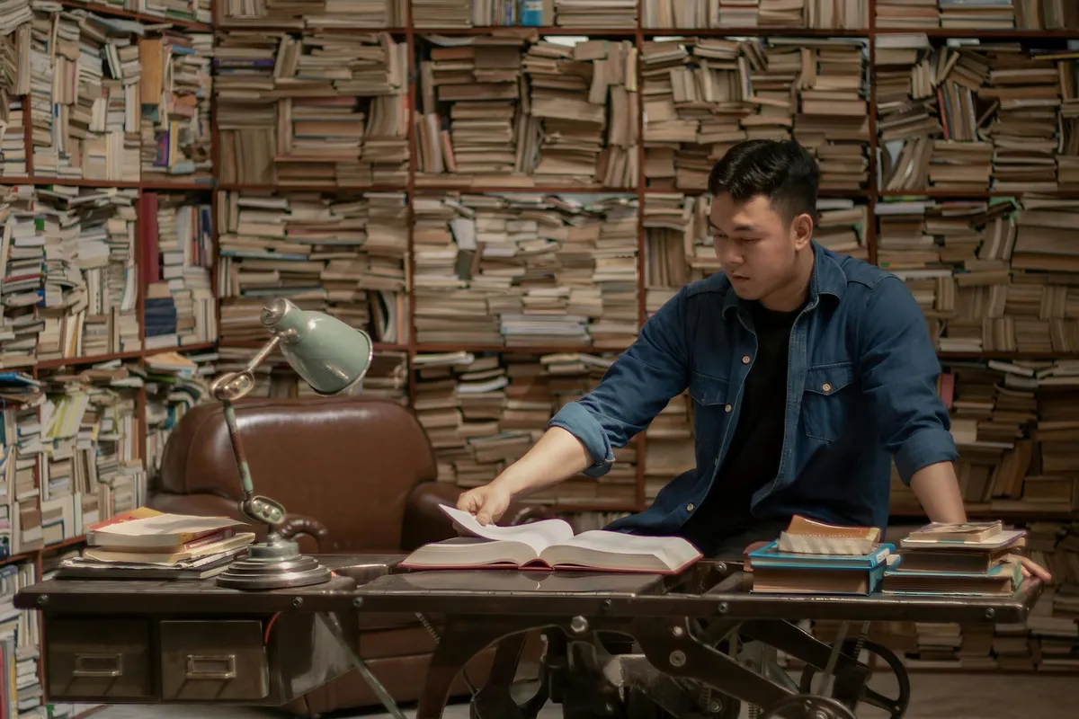 A student studying with notes and books at a desk