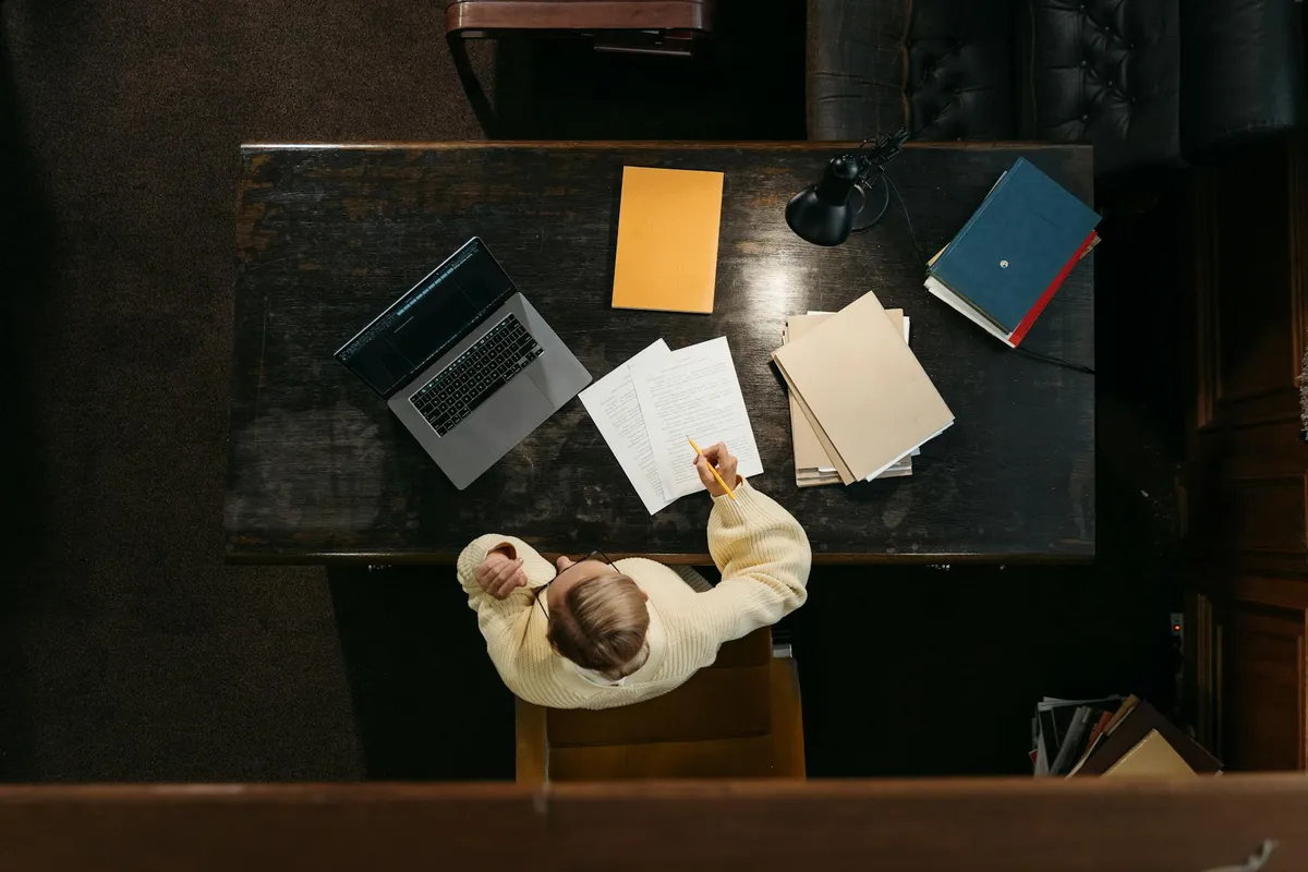 A student working on an academic paper at a desk